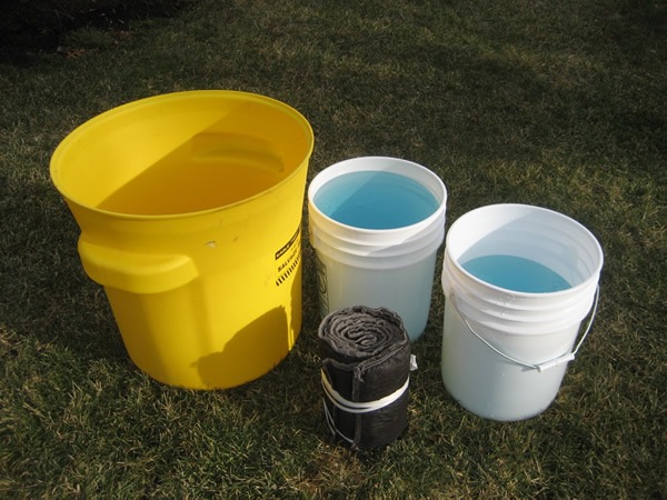 Buckets filled with solution and Suber absorbent sock before soaking